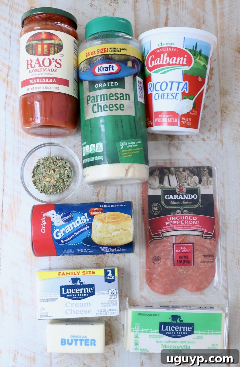 pizza dip recipe ingredients on a white wood board
