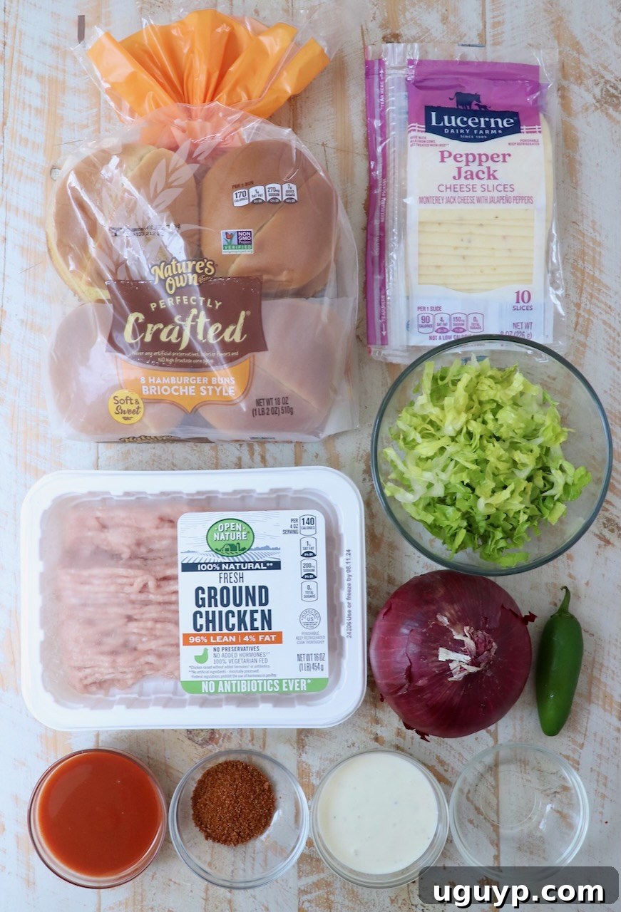 all the fresh ingredients for buffalo chicken smash burgers neatly arranged on a rustic white wood board