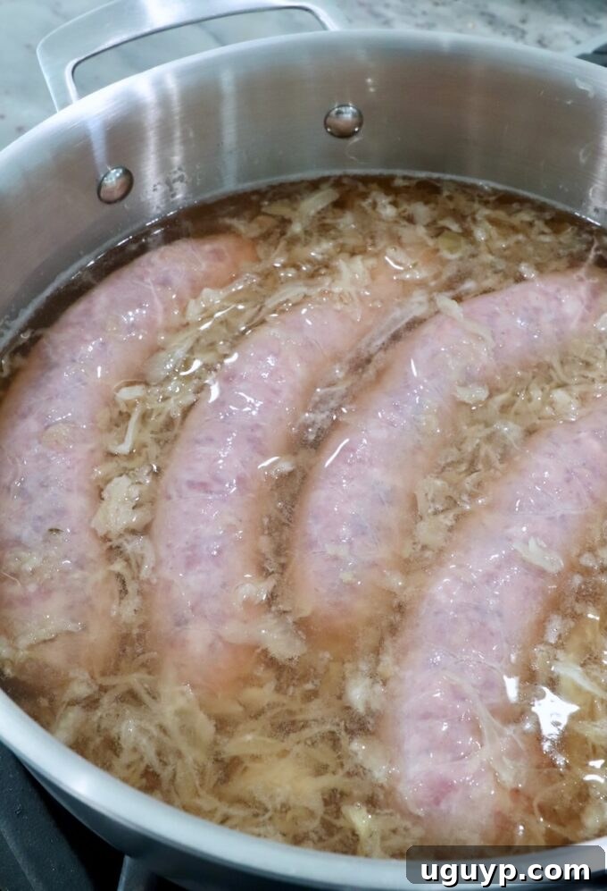 bratwurst in pan with beer and sauerkraut