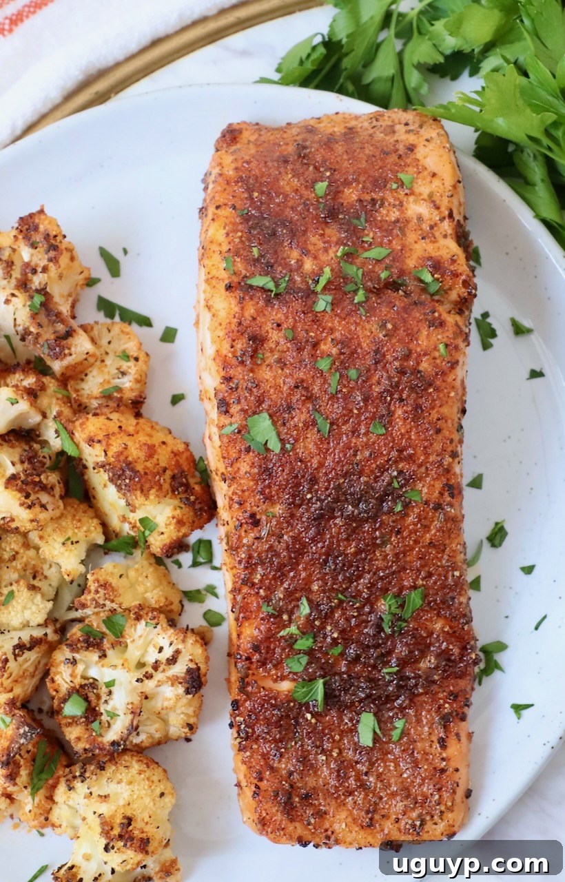 seasoned cooked salmon on plate with roasted cauliflower