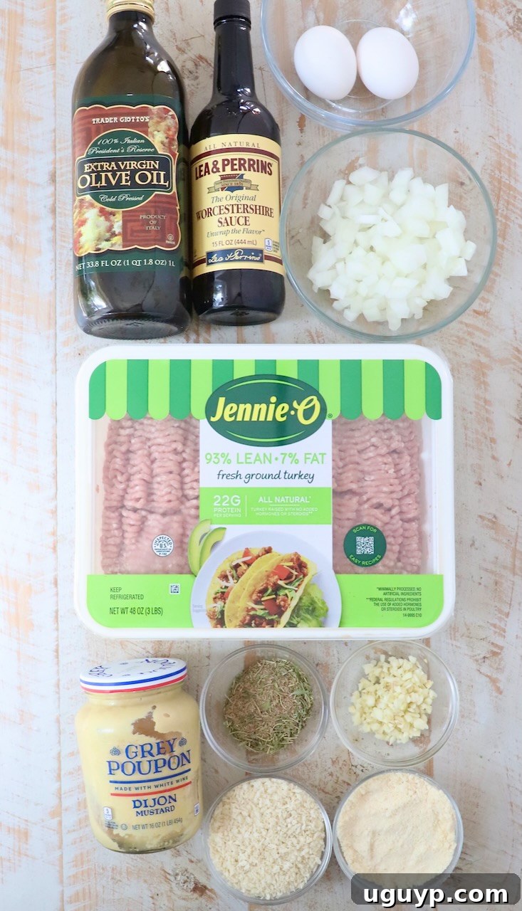 Fresh ingredients for making turkey meatballs laid out on a white wooden board, highlighting quality and freshness.