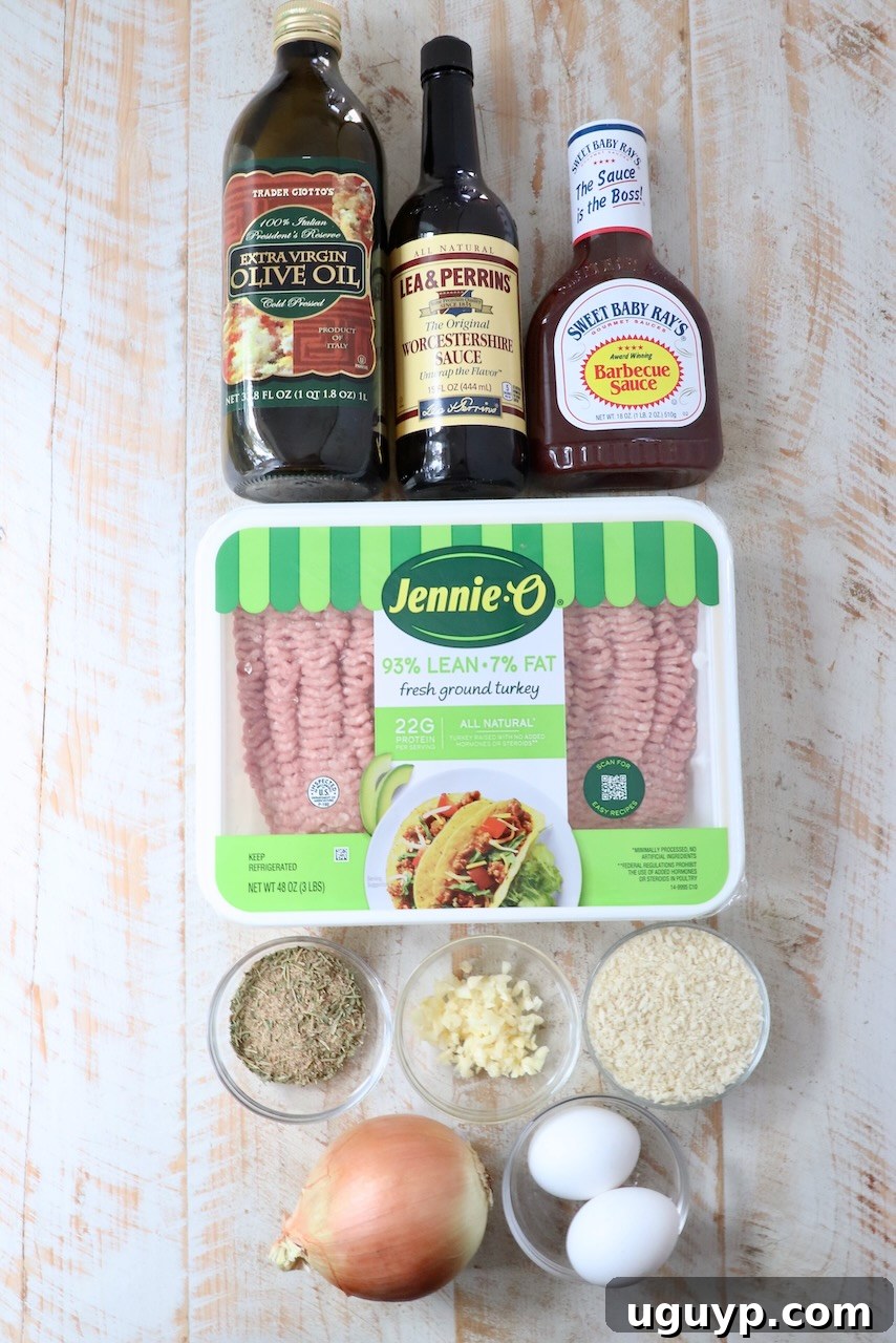 Fresh ingredients for turkey meatloaf arranged on a white wooden board, ready for preparation.