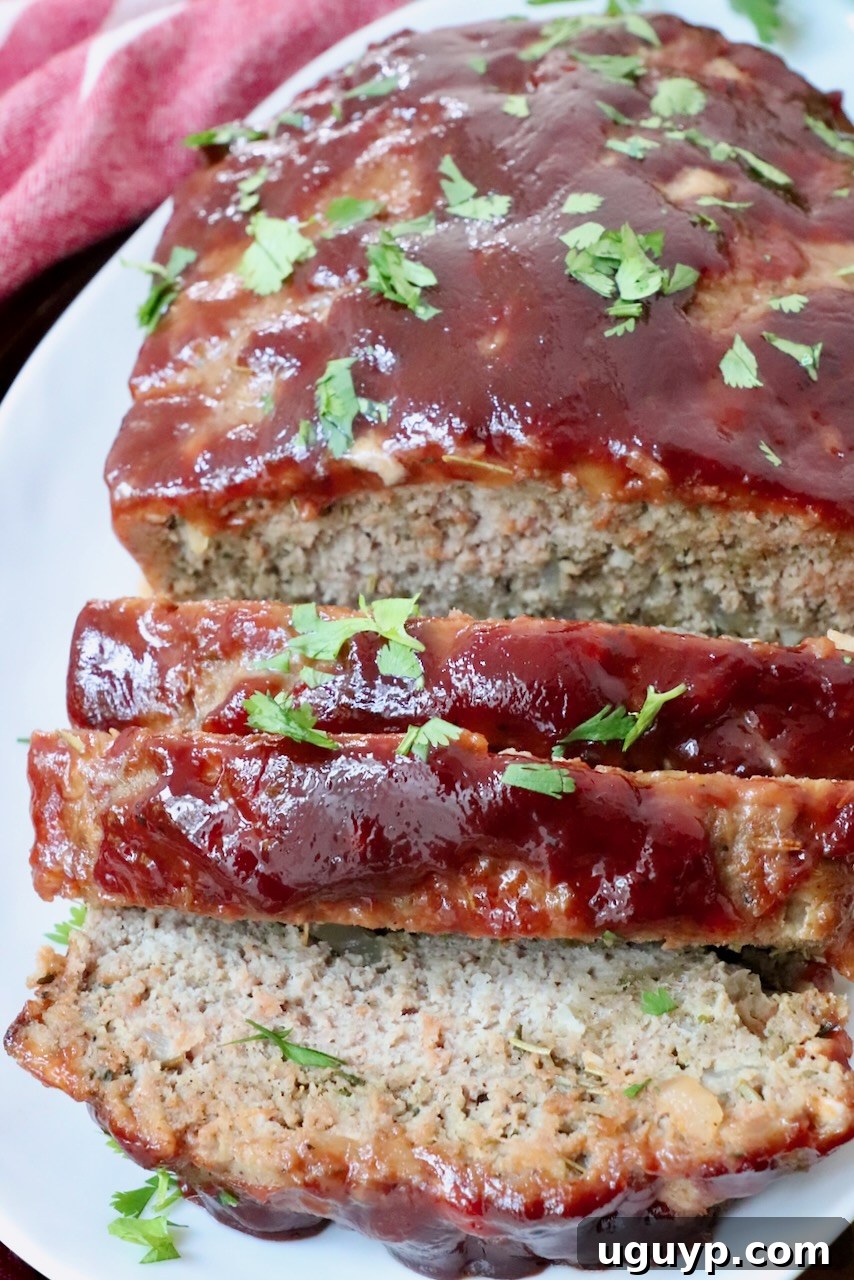 Beautifully sliced turkey meatloaf on a clean plate, ready to be served as a hearty meal.