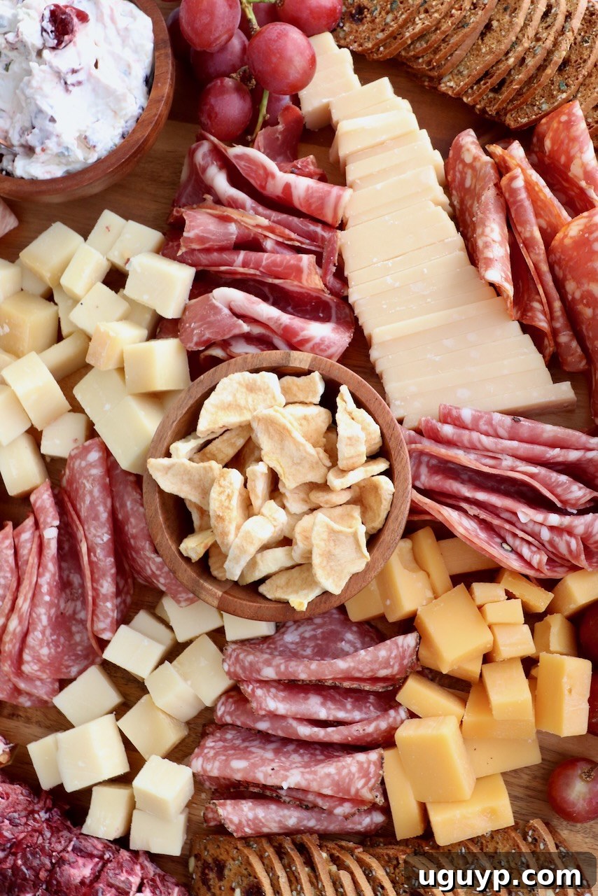 An overhead shot of a vibrant Fall Charcuterie Board, laden with an array of colorful meats, cheeses, crackers, and seasonal fruits, ready for enjoyment.
