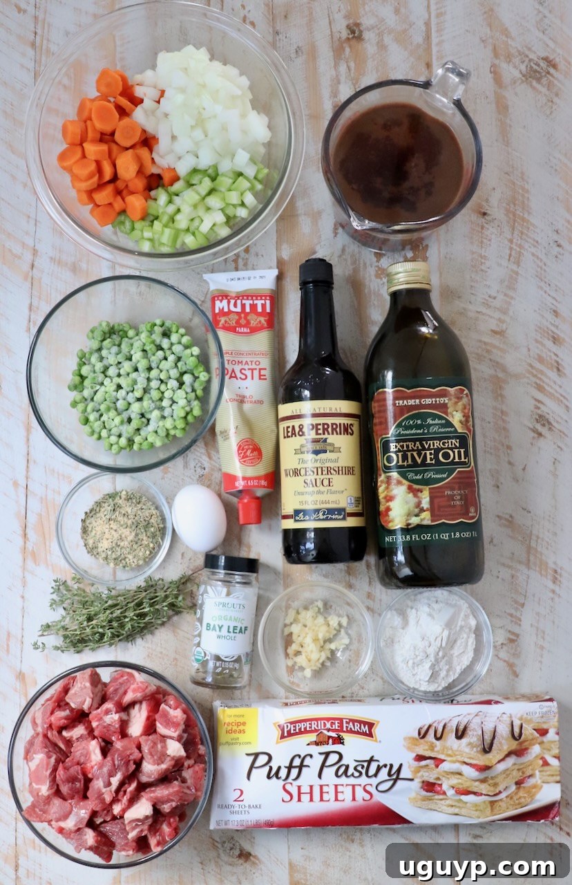 ingredients for beef pot pie on a white wood board