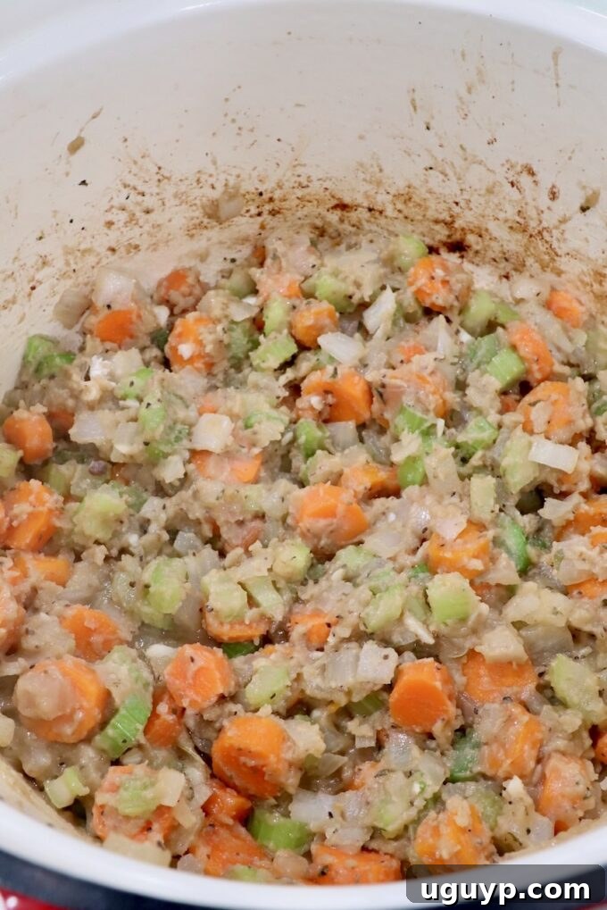 flour mixed with diced vegetables in a dutch oven