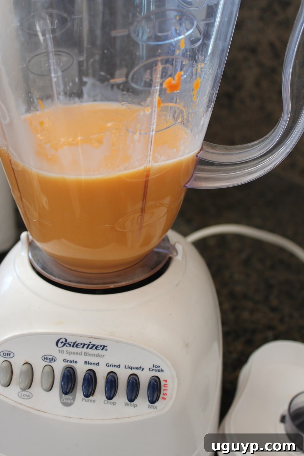 A blender filled with pureed sweet potato and milk, ready to be heated for a Goguma Green Tea Latte.