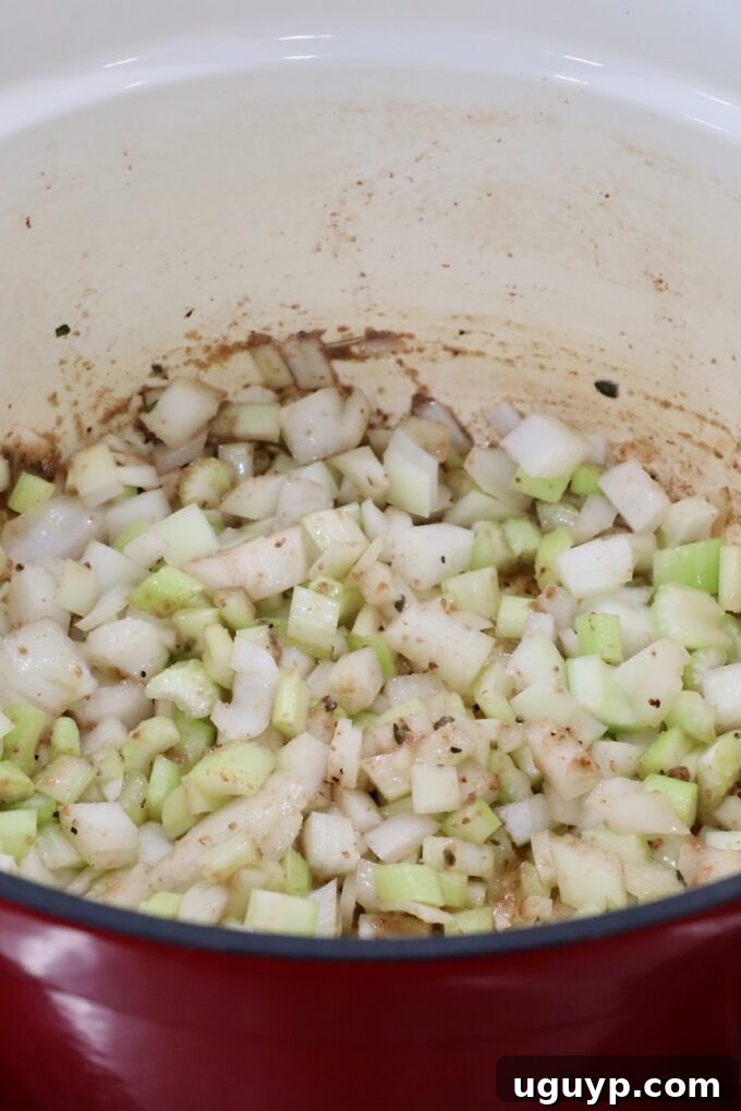 Sautéed diced onions and celery in a Dutch oven, creating an aromatic base.