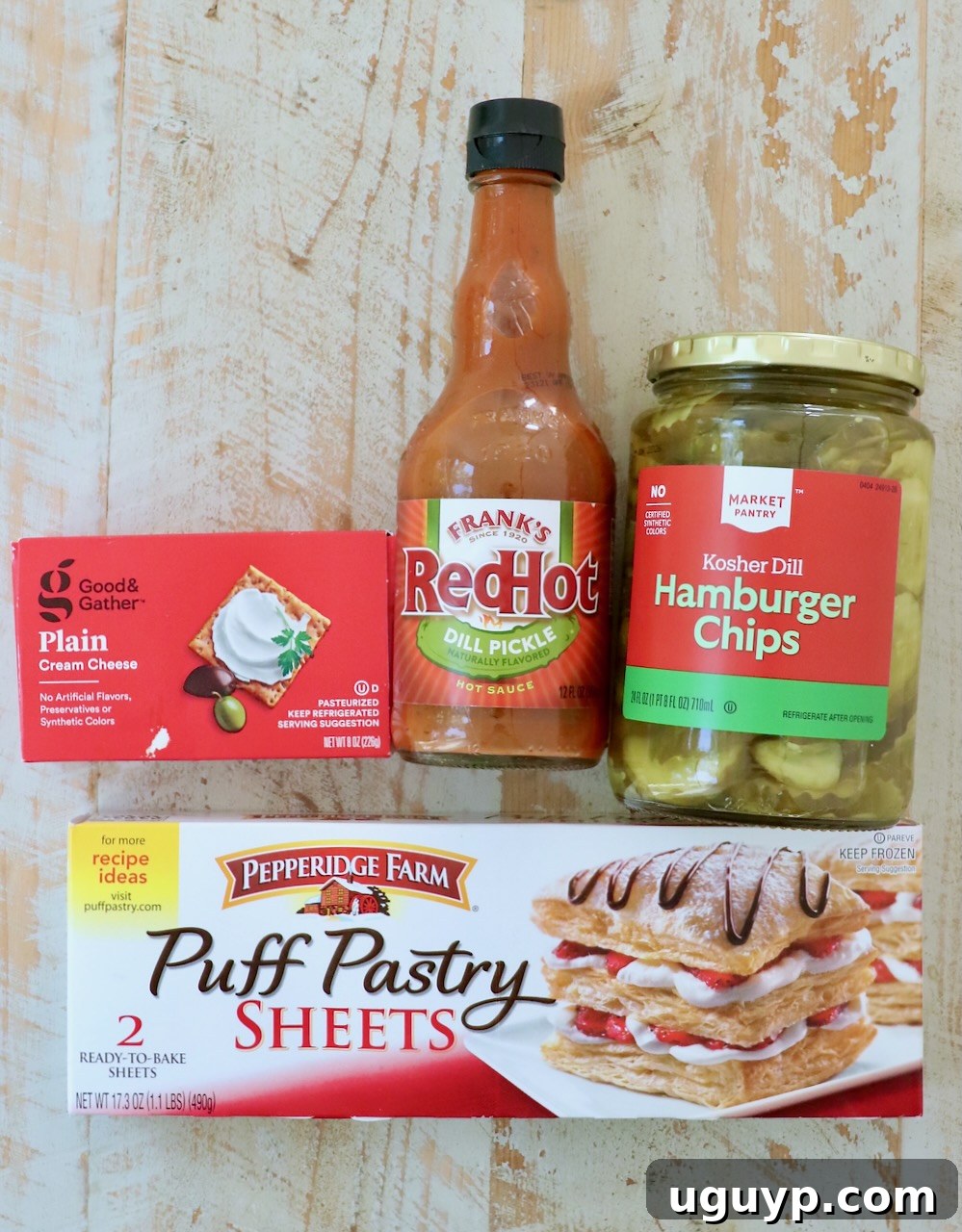ingredients for puff pastry pickle bites on a white wood board