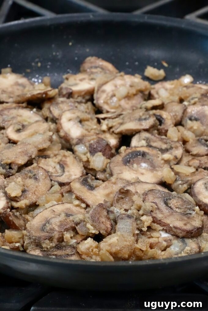 All-purpose flour sprinkled over the mushrooms and butter, creating a roux to thicken the gravy.
