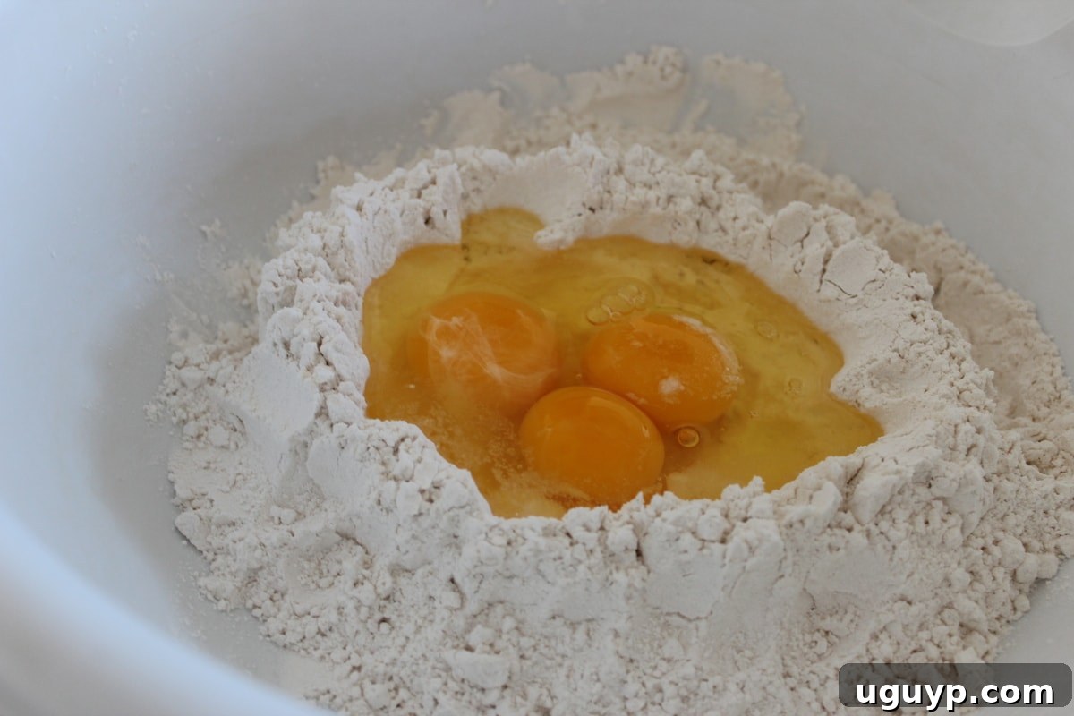 eggs in the middle of flour in a large bowl