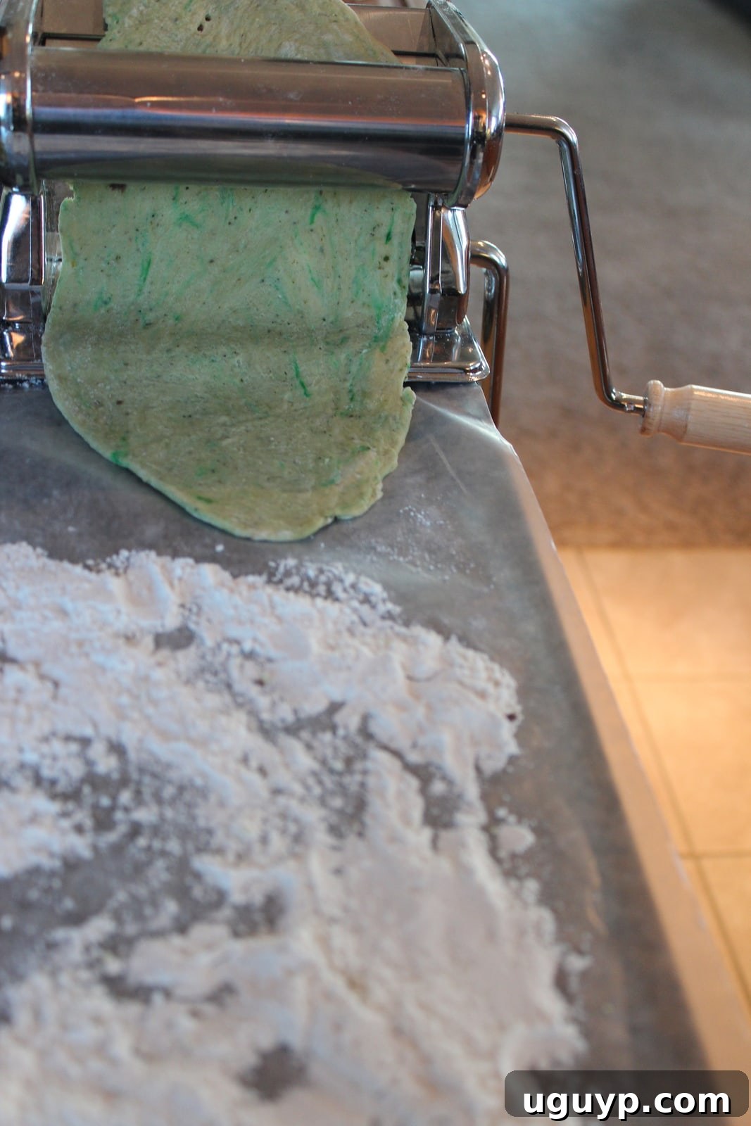 green pasta dough in a pasta machine