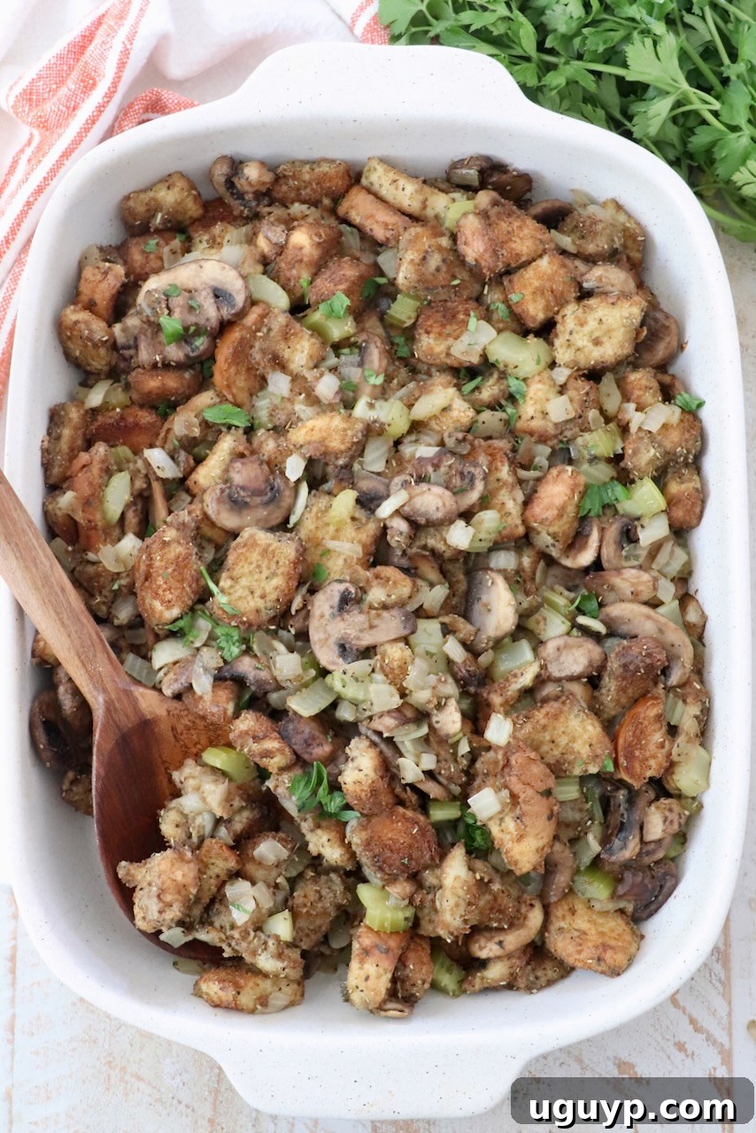 mushroom stuffing in a casserole dish with a serving spoon