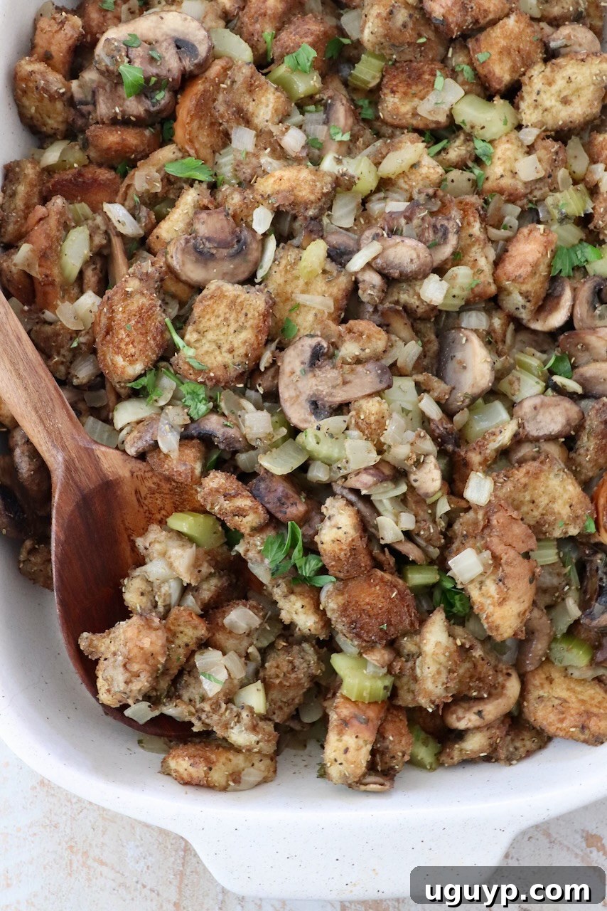 stuffing in a casserole dish with a serving spoon