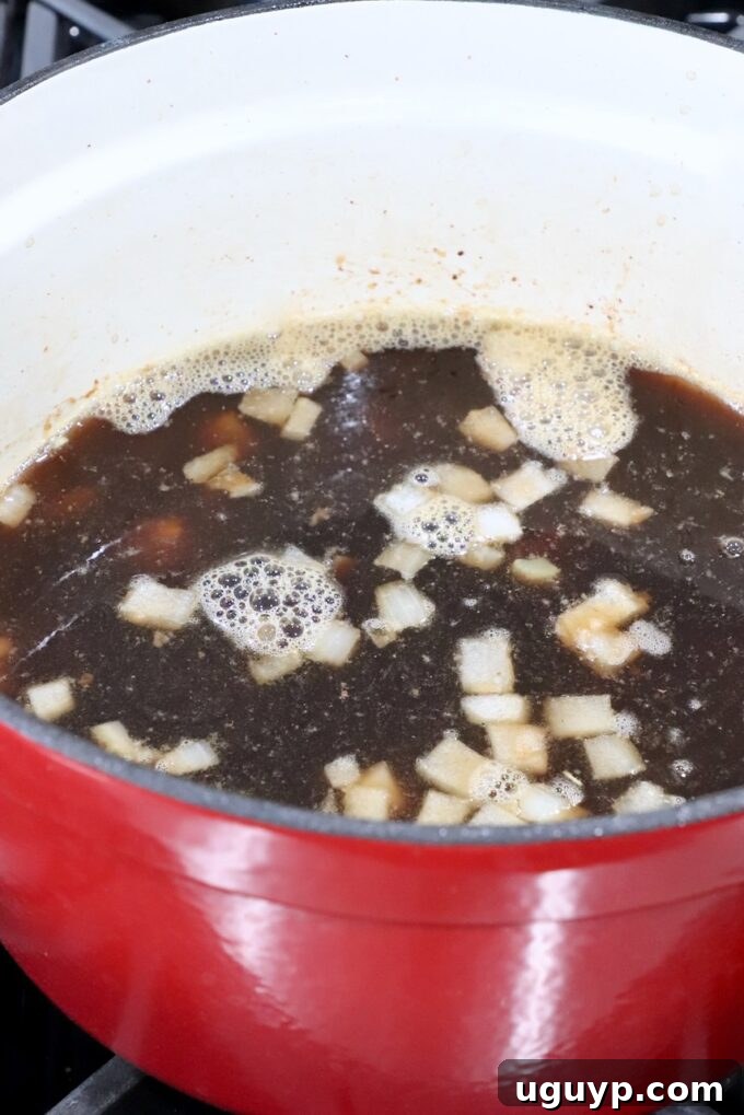 Ingredients simmering together in the Dutch oven, creating the rich stew base.