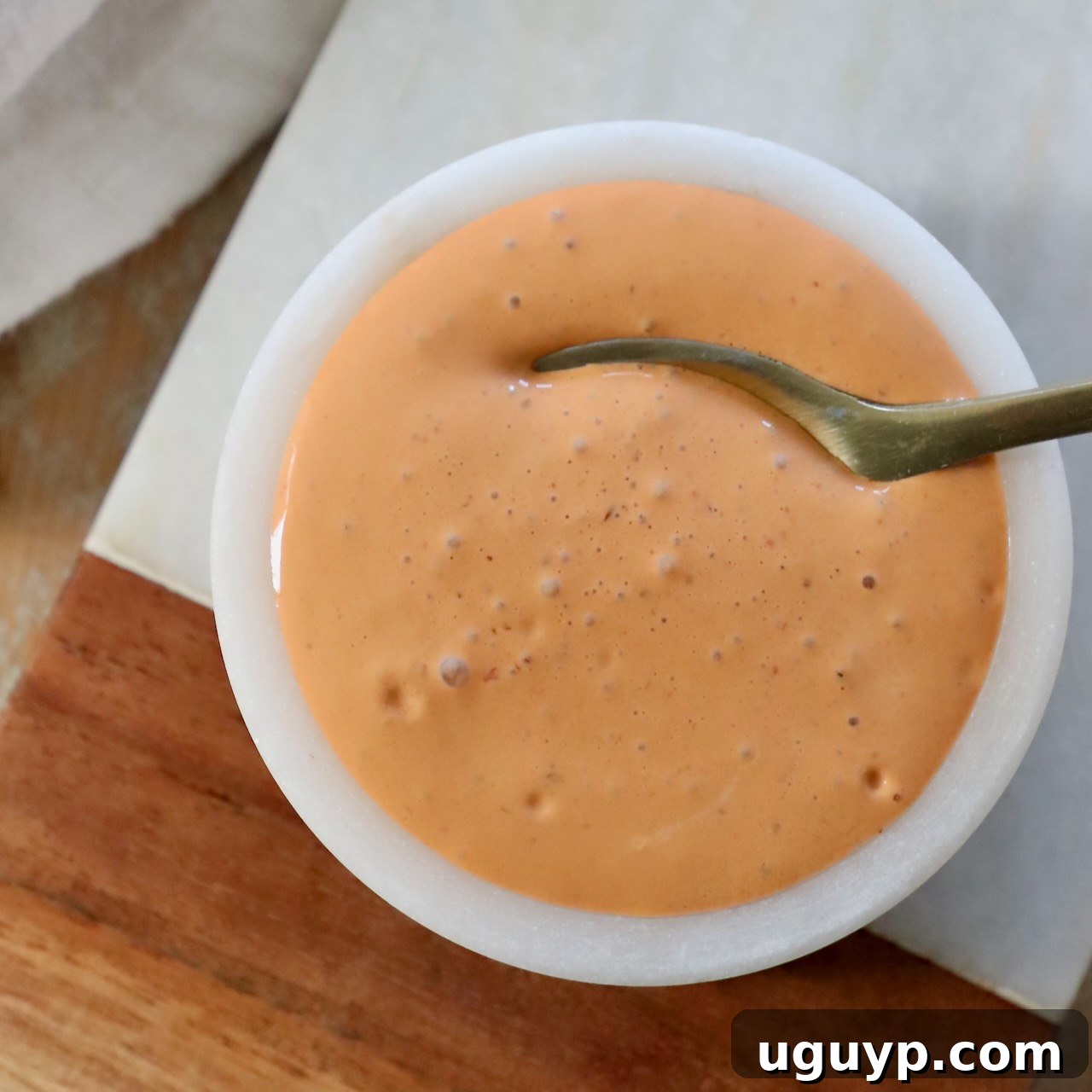 Creamy chipotle sauce in a bowl with a spoon