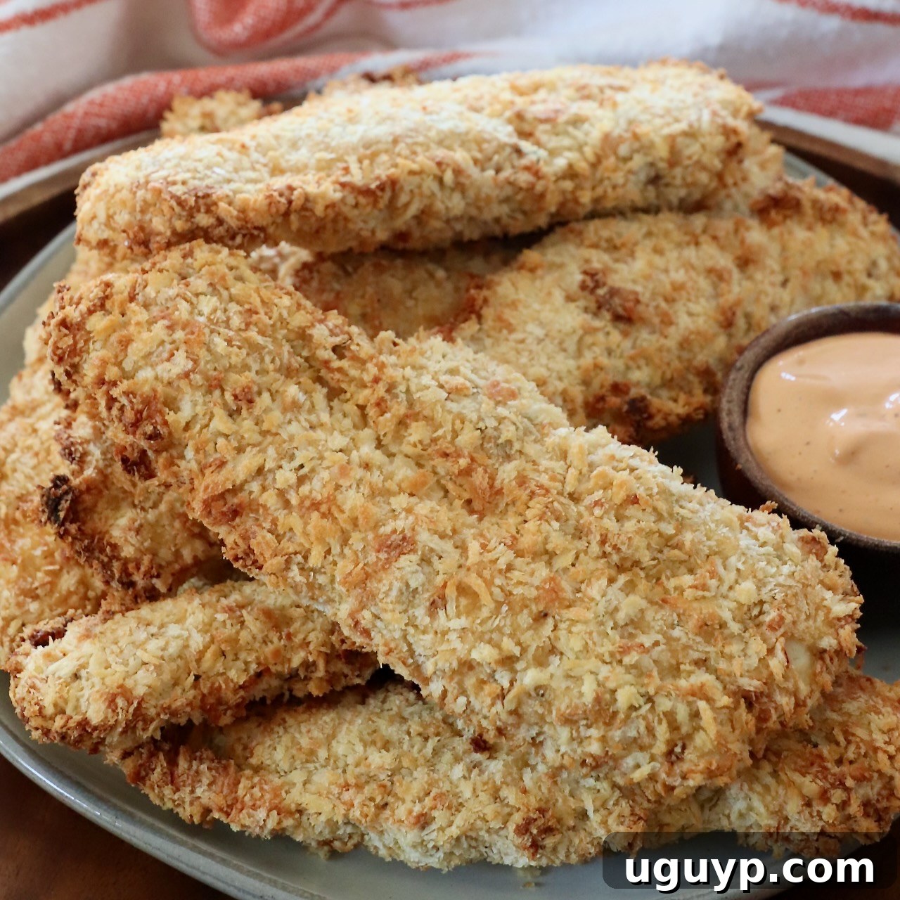 Cooked, breaded chicken strips on a plate, made in an Air Fryer