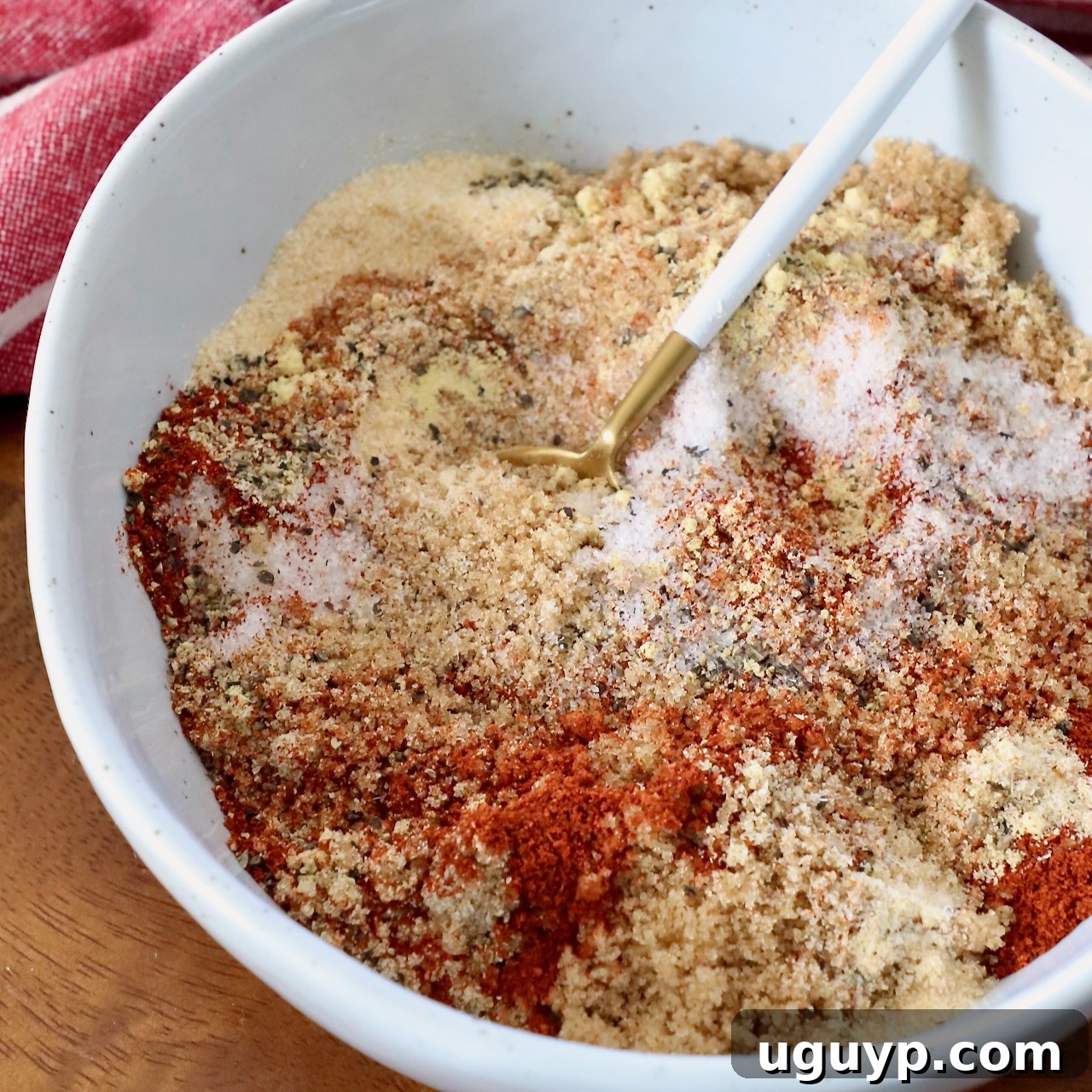 Spices mixed with brown sugar in a bowl with a spoon, for rib rub