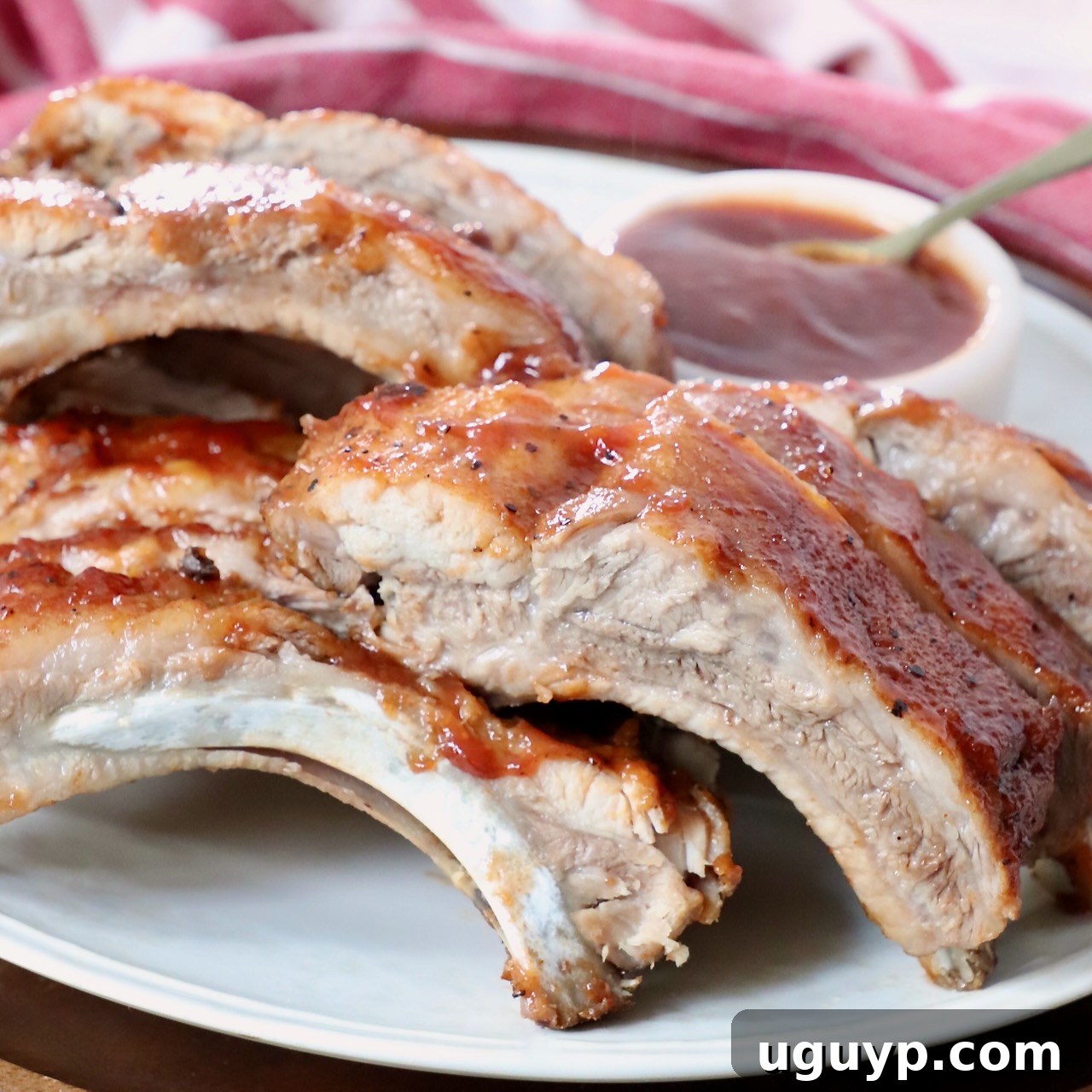 Cooked pork ribs on a plate brushed with BBQ sauce, made in an Instant Pot