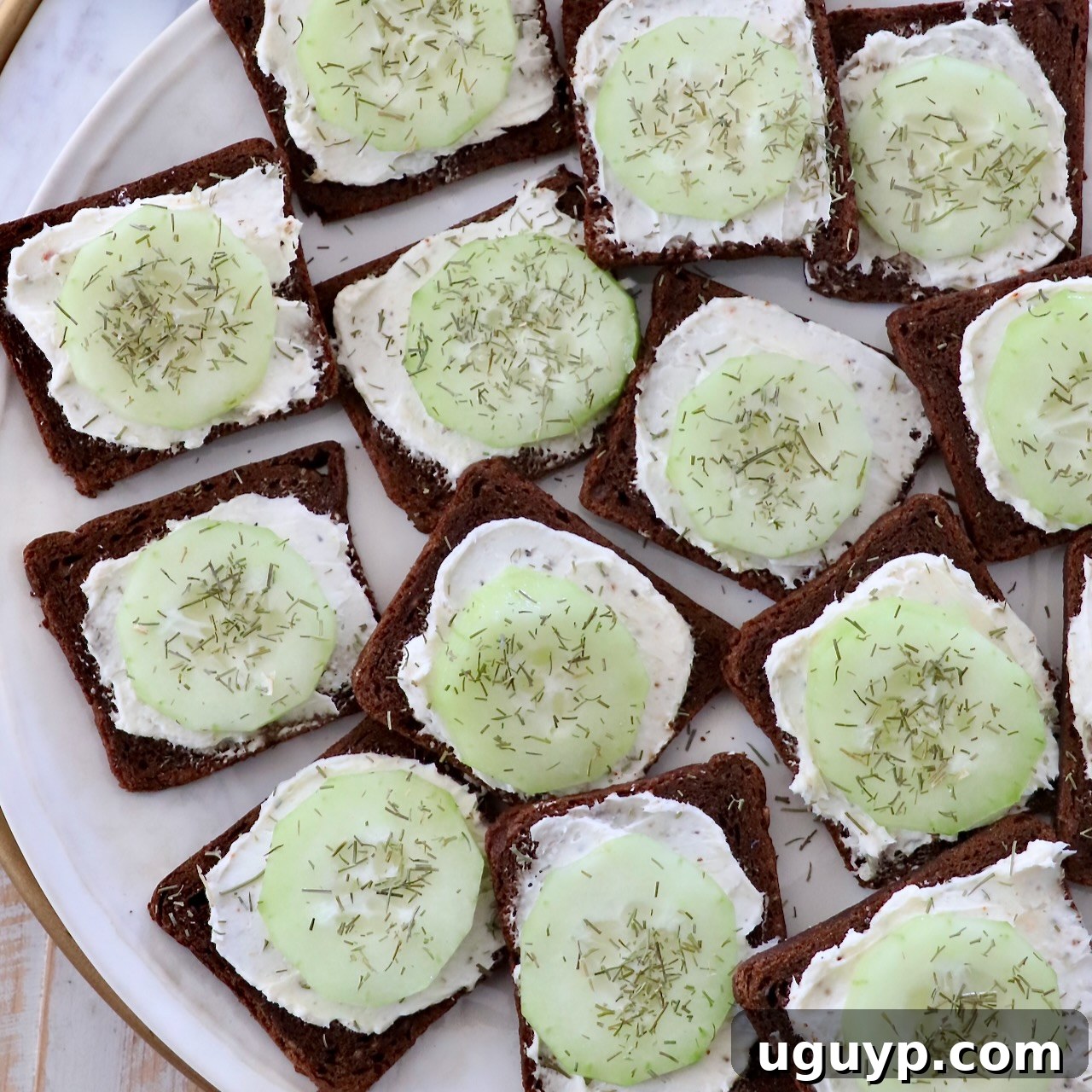 Open-faced cucumber tea sandwiches on a plate