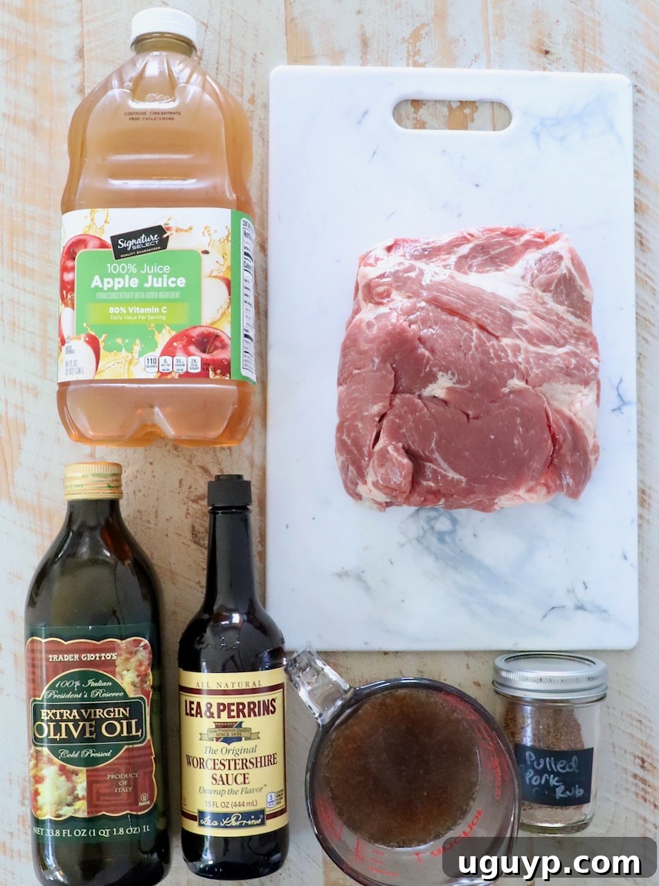 Assortment of fresh ingredients laid out on a white wooden board for making pulled pork.