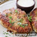 Pan-fried breaded pork chop on a plate, ready to be served.