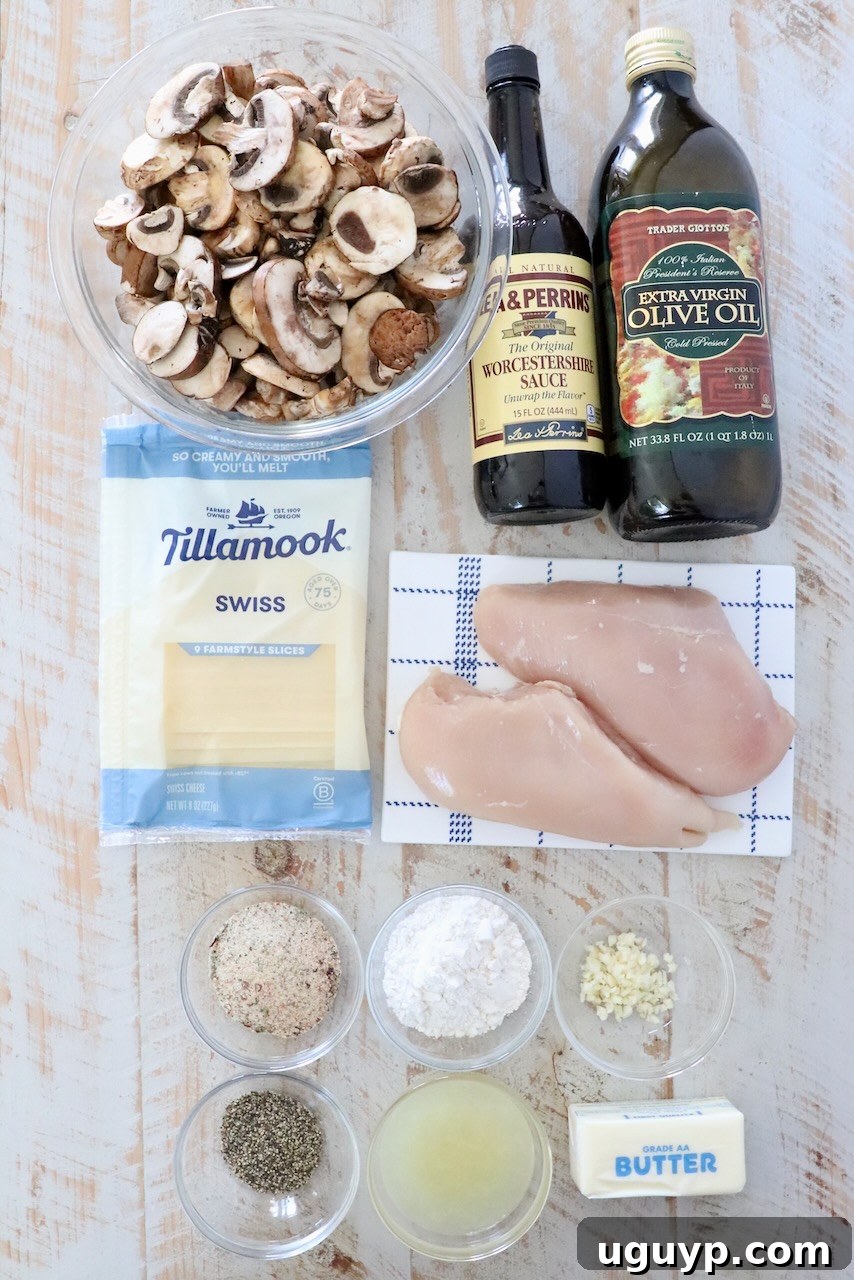 ingredients for mushroom chicken on a white wood board