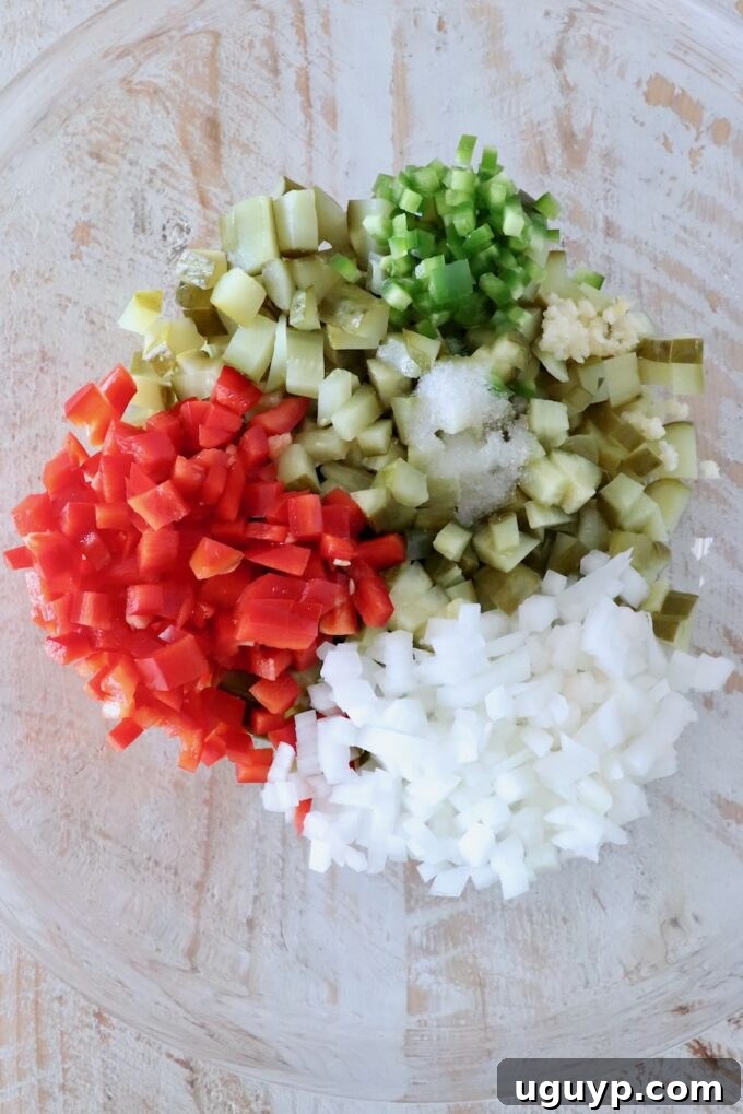 diced pickles, onions and peppers separated in a glass bowl