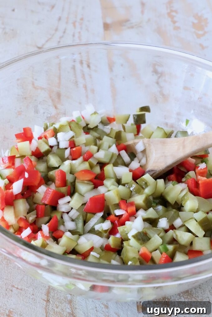 pickle de gallo mixed together in a glass bowl with a spoon