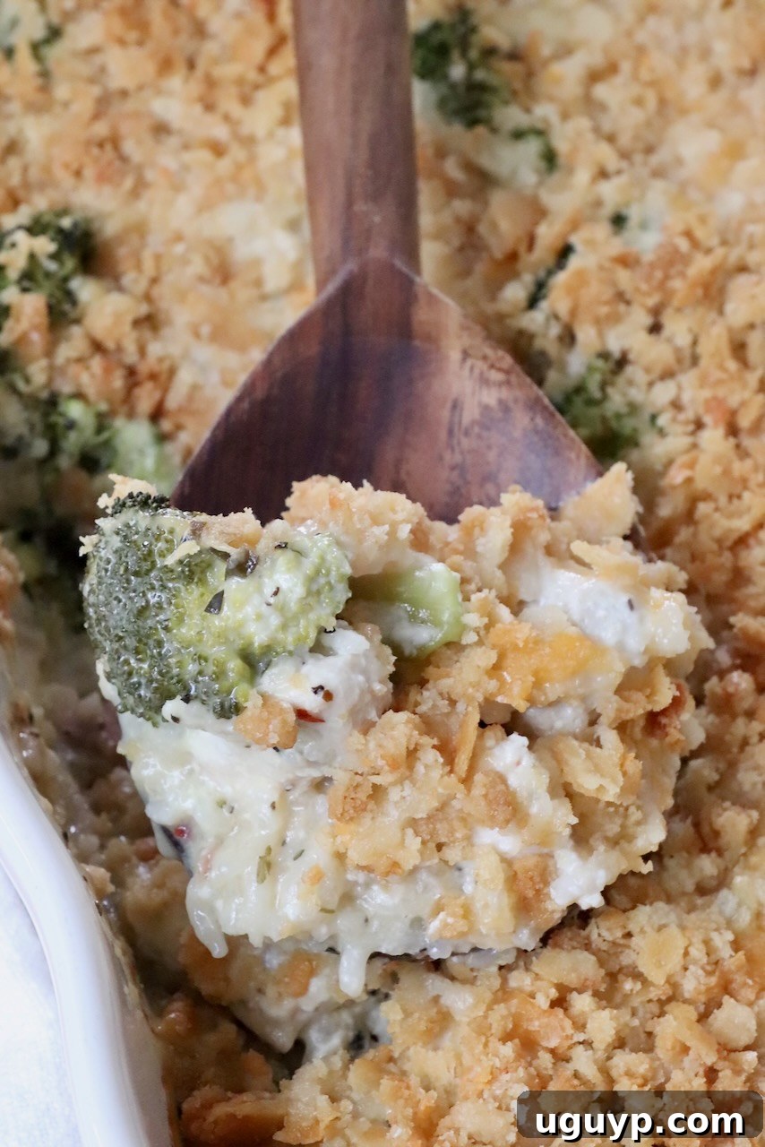 baked chicken broccoli rice casserole in a dish with a serving spoon, ready to be served