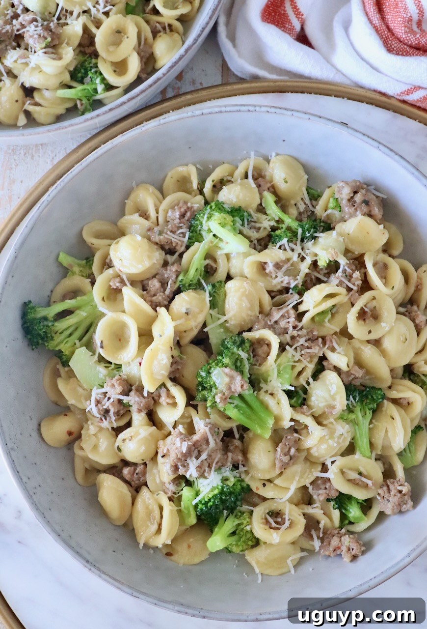 cooked orecchiette pasta with broccoli and Italian sausage in a bowl