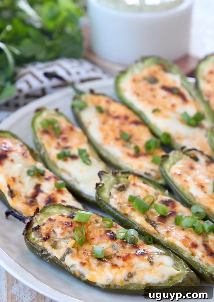 Cheese-stuffed grilled jalapenos on a plate, ready to be served