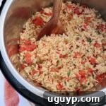 cooked Mexican rice in an Instant Pot with a large serving spoon