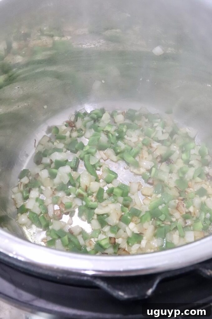 diced onions, jalapenos and garlic being sautéed in an Instant Pot