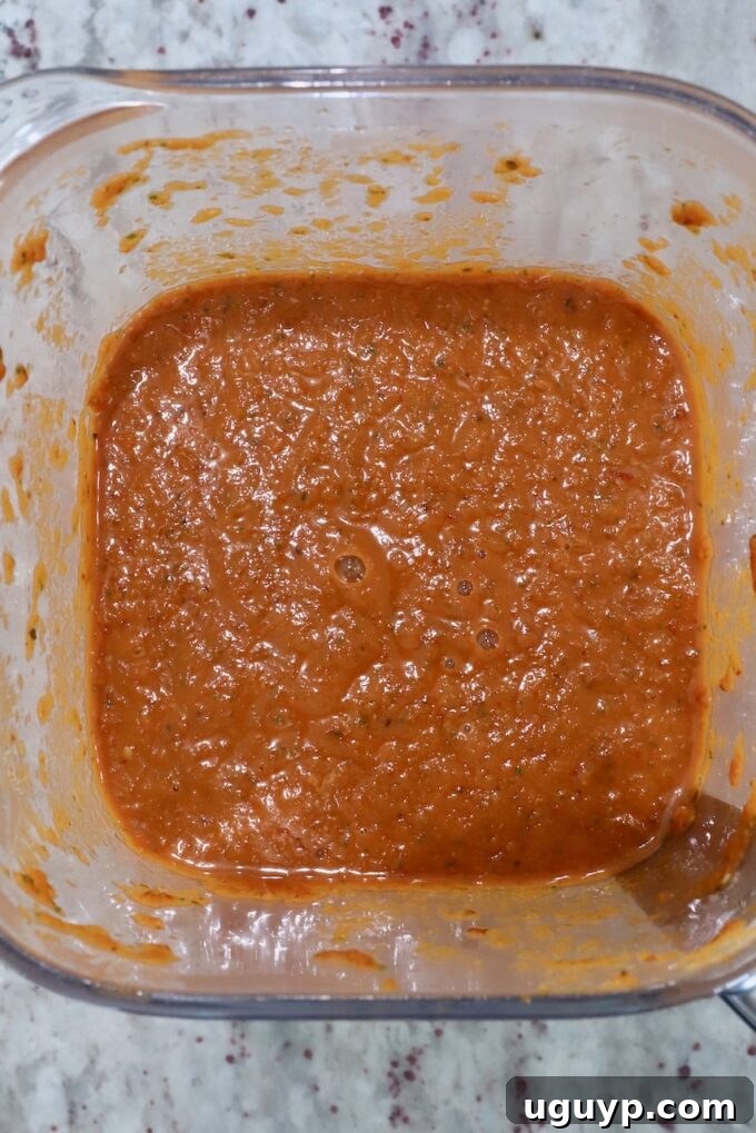 Smooth, pureed adobo sauce in a blender, perfectly ready for simmering with the chicken.