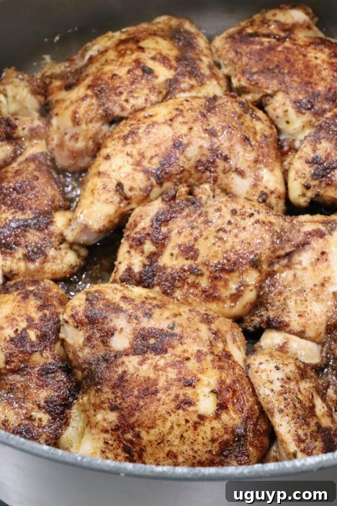 Perfectly seared chicken thighs in a large Dutch oven, displaying a rich, caramelized crust before adding the sauce.