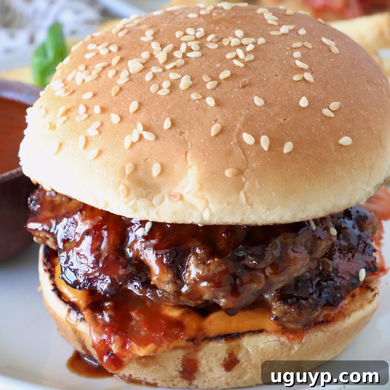 prepared burger on a plate with korean bbq sauce