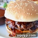 burger covered in bbq sauce on a plate