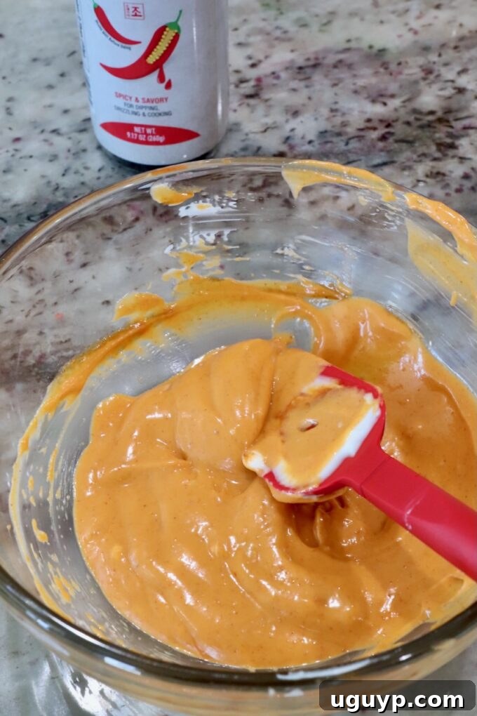 gochujang mayonnaise in a glass bowl with a red spatula