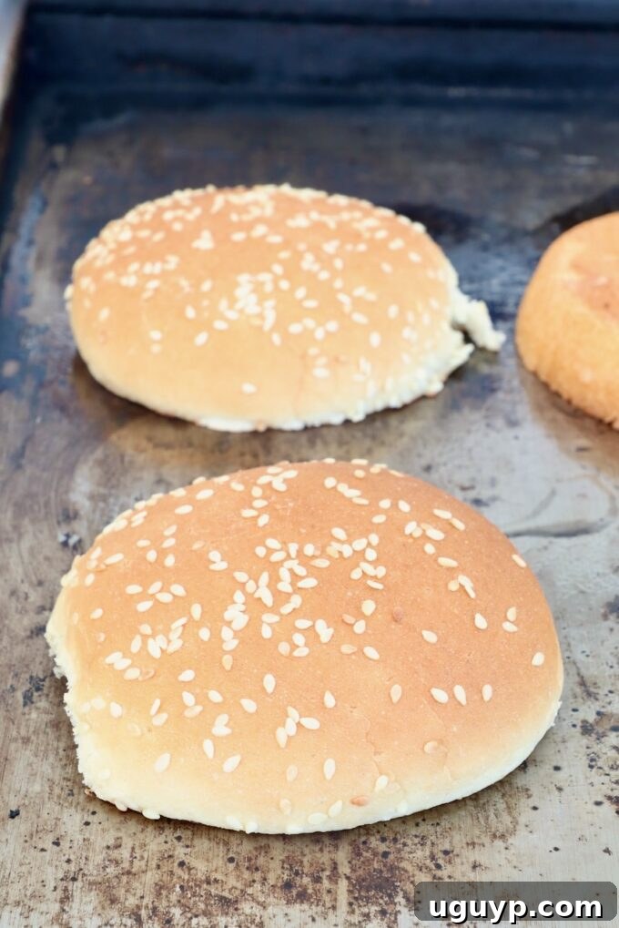 sesame seed buns on a griddle