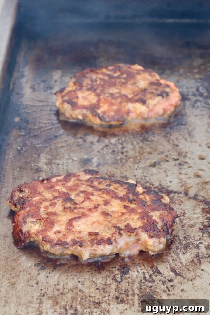 grilled burger patties on a griddle