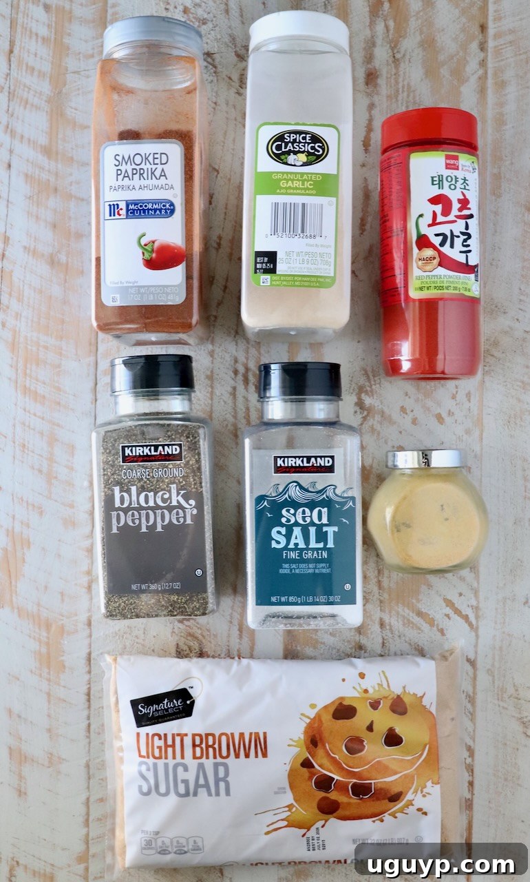An overhead shot showcasing the individual ingredients for Korean BBQ seasoning, each in its own container, neatly arranged on a rustic white wooden board.