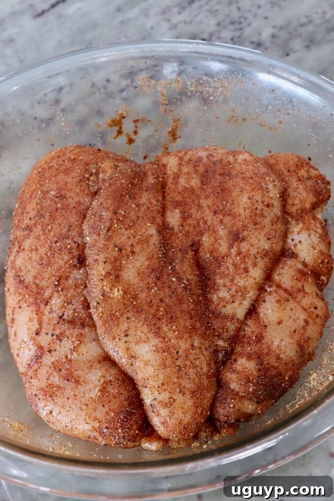 seasoned chicken breasts in a glass bowl