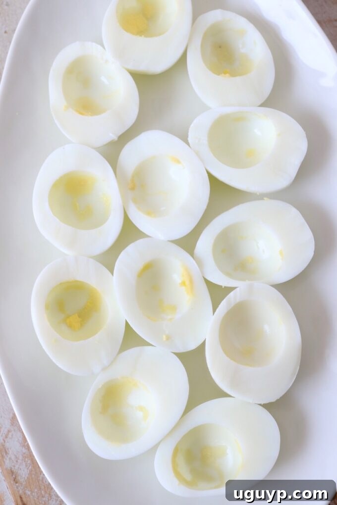 hard boiled egg whites on plate with the yolks removed