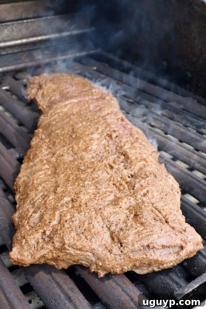 marinated skirt steak on a hot grill, sizzling and cooking