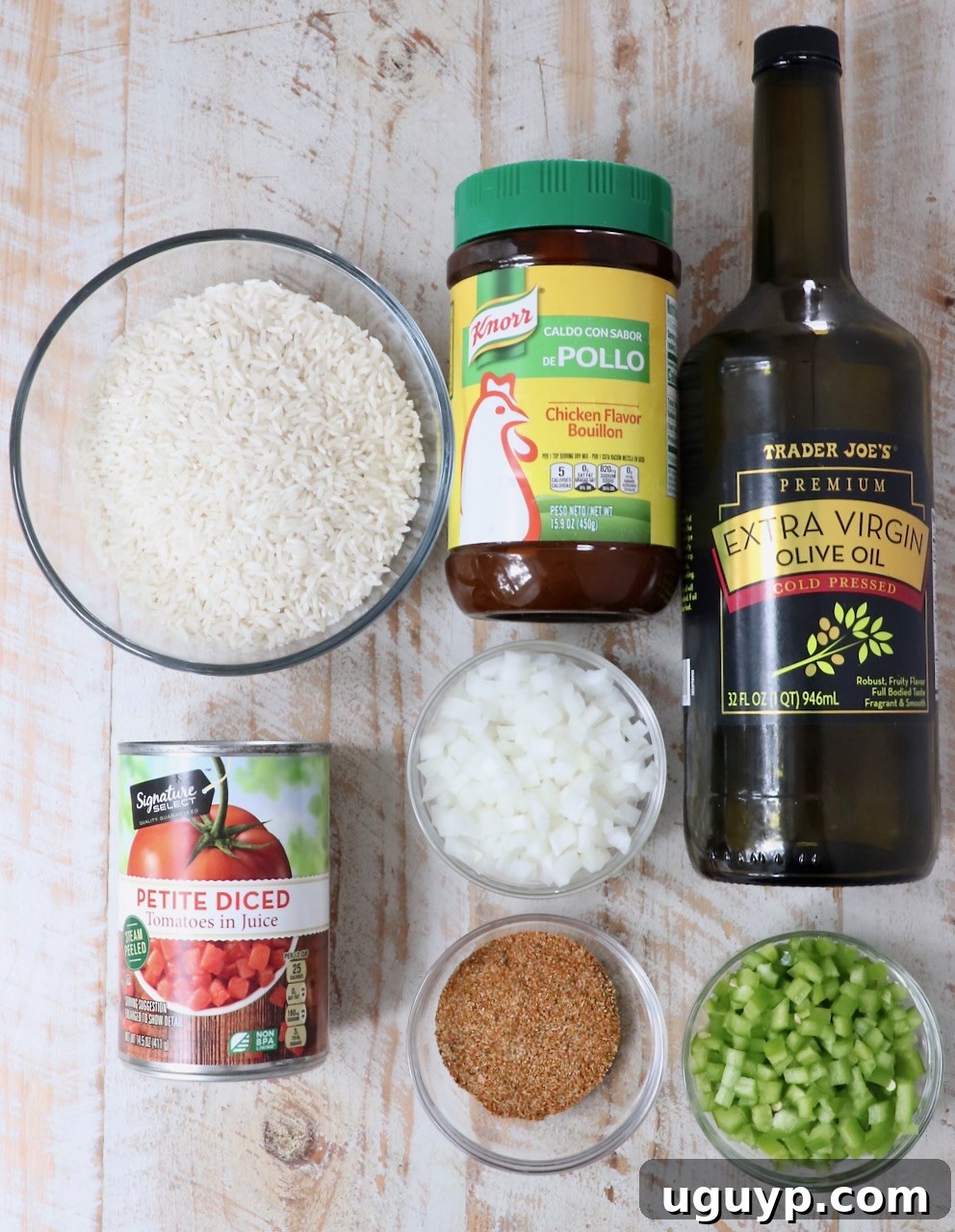 ingredients for yellow rice on a white wood board