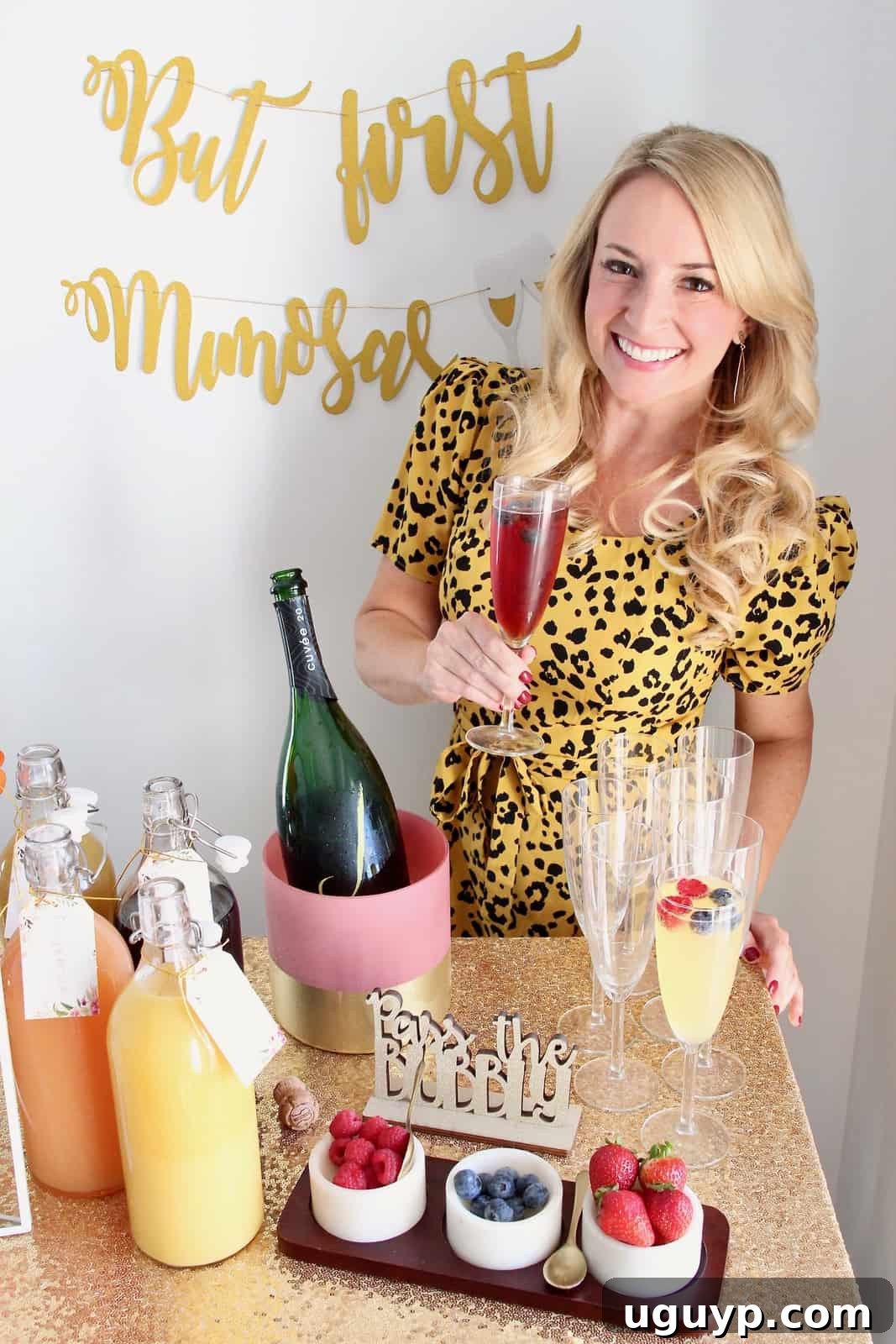 Woman enjoying a mimosa she prepared at a well-appointed mimosa bar