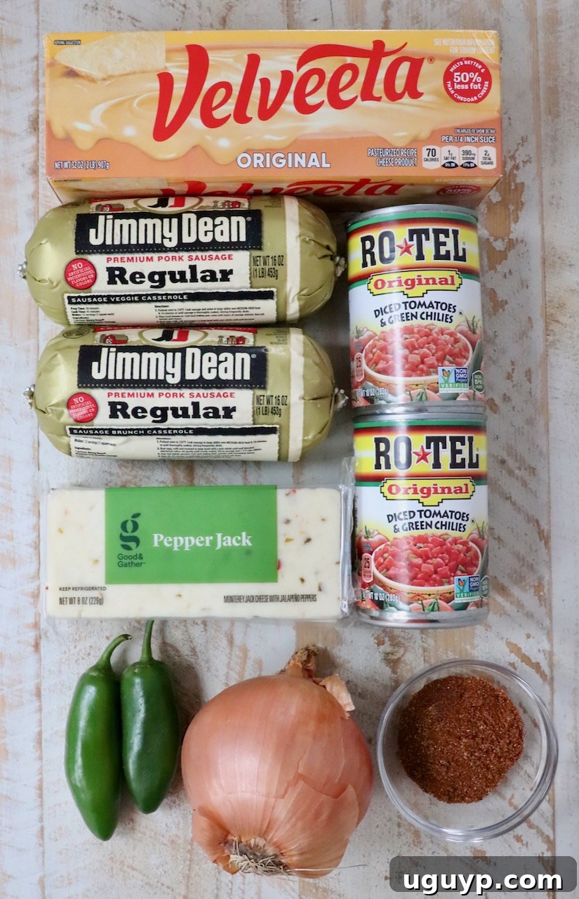 ingredients for smoked queso on a white wood board