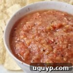 peach salsa in a bowl surrounded by tortilla chips, ready to be served