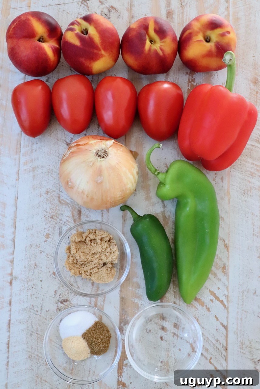 Ingredients for homemade peach salsa laid out on a white wooden board, including fresh peaches, tomatoes, peppers, and onions
